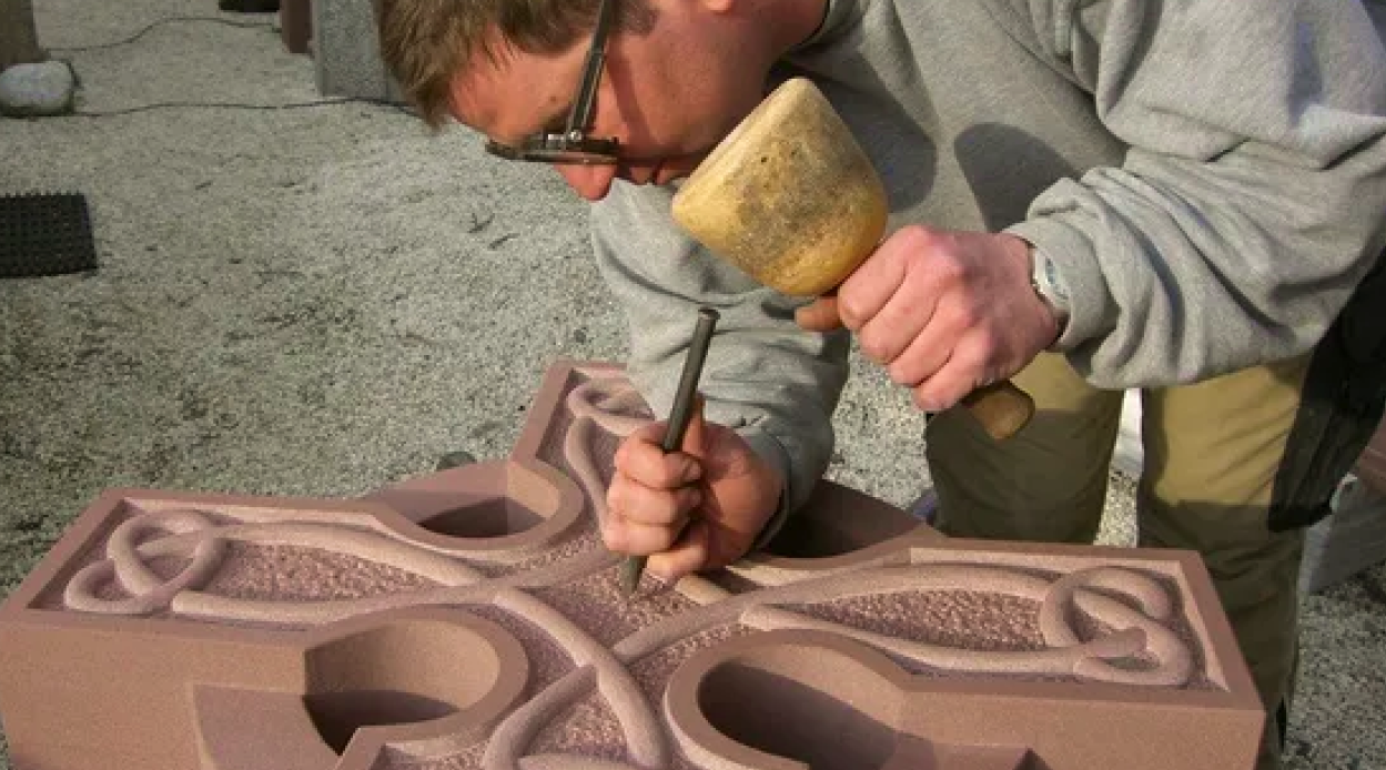 Bildhauer bei der Arbeit. Einsatz von Knüpfel und Spitzeisen
